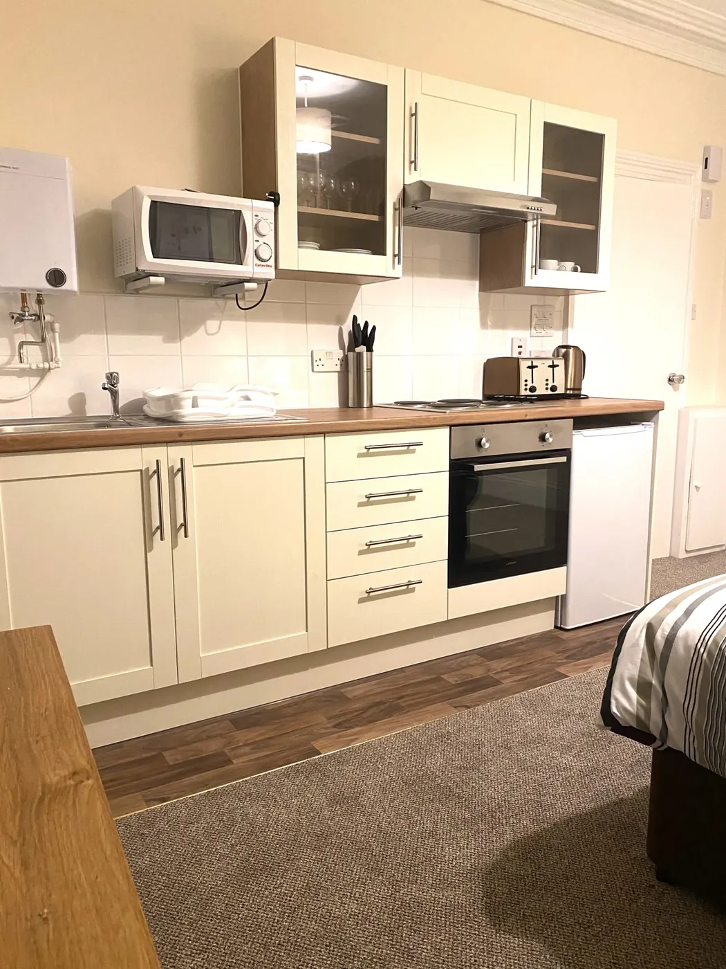 Kitchen and bed in the Studio Apartment